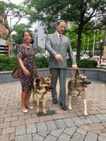 Haben and Mylo next to guide dog statue at The Seeing Eye