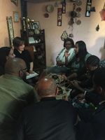 Haben and team enjoying coffee at a short table in Mekele.