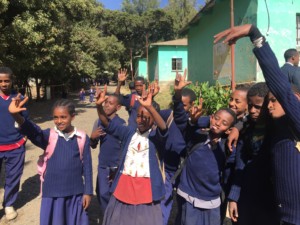 Children waving goodbye at deaf school